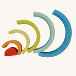 The Grimm's Babi Gwawr Sunrise 6 Piece Rainbow on a plain background.  The pieces are shown spread out in a fan-like pattern.
