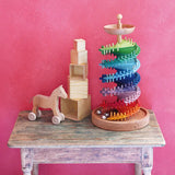 Grimms handcrafted wooden ball run assembly set displayed with natural stacking cubes and push along horse