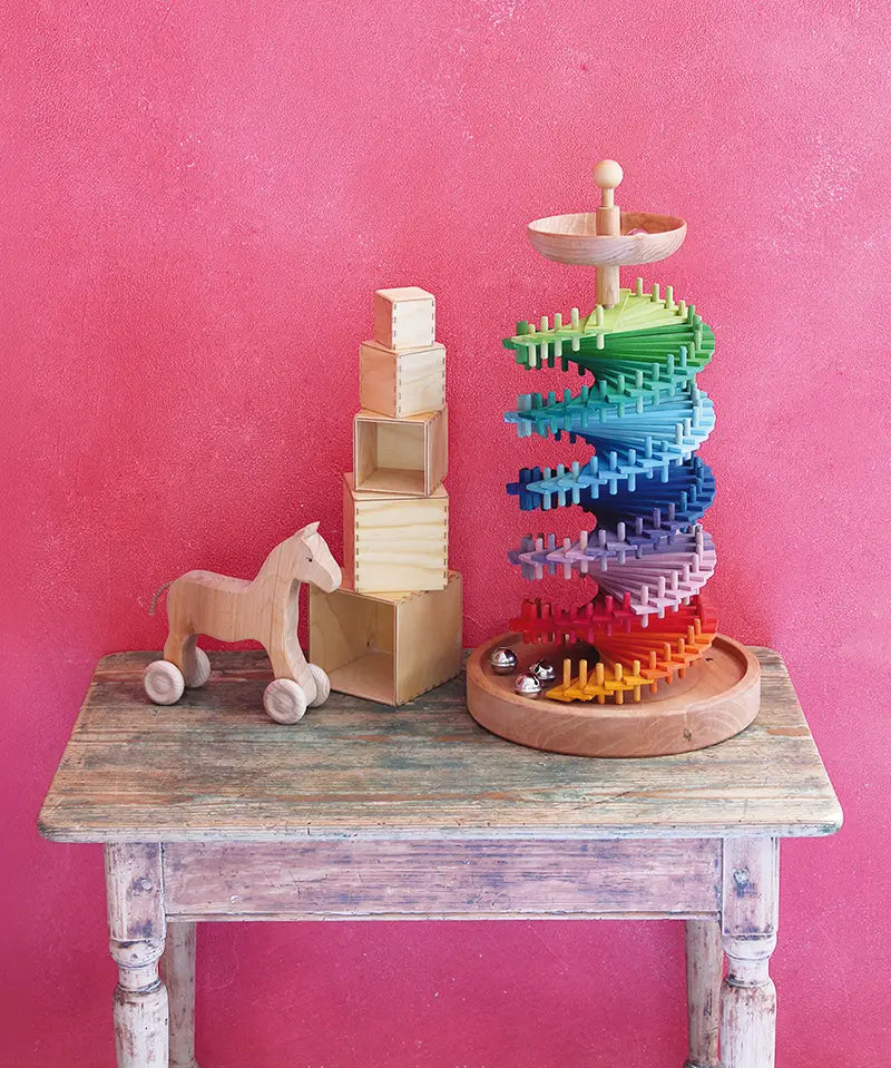 Grimms handcrafted wooden ball run assembly set displayed with natural stacking cubes and push along horse