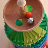 Grimms handcrafted wooden ball run assembly set showing a close up of the start bowl with a wooden marble and bell inside