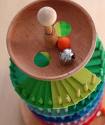 Grimms handcrafted wooden ball run assembly set showing a close up of the start bowl with a wooden marble and bell inside