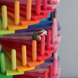 Grimms handcrafted wooden ball run assembly set showing a close up of a marble running down the colourful slats