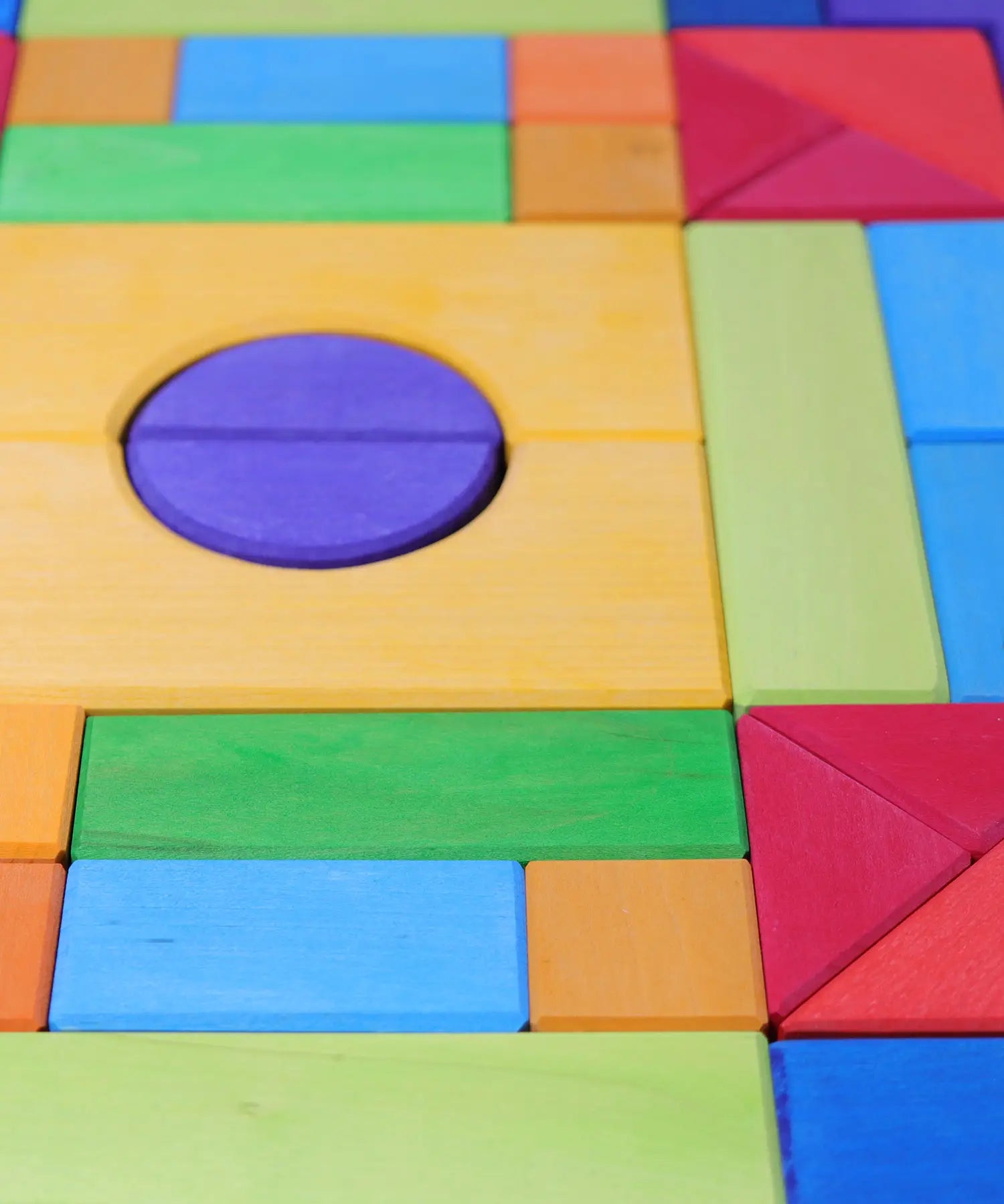 Grimm's Basic Building Set 2 wooden block set showing close up of wood grain detail on the individual blocks in a rainbow palette 