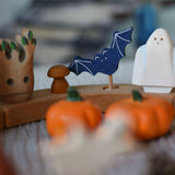 A Grimm's wooden bat decorative figure placed on a natural Grimm's celebration ring. The decorative figures are part of a wide range of figures and rings available here at Babipur.