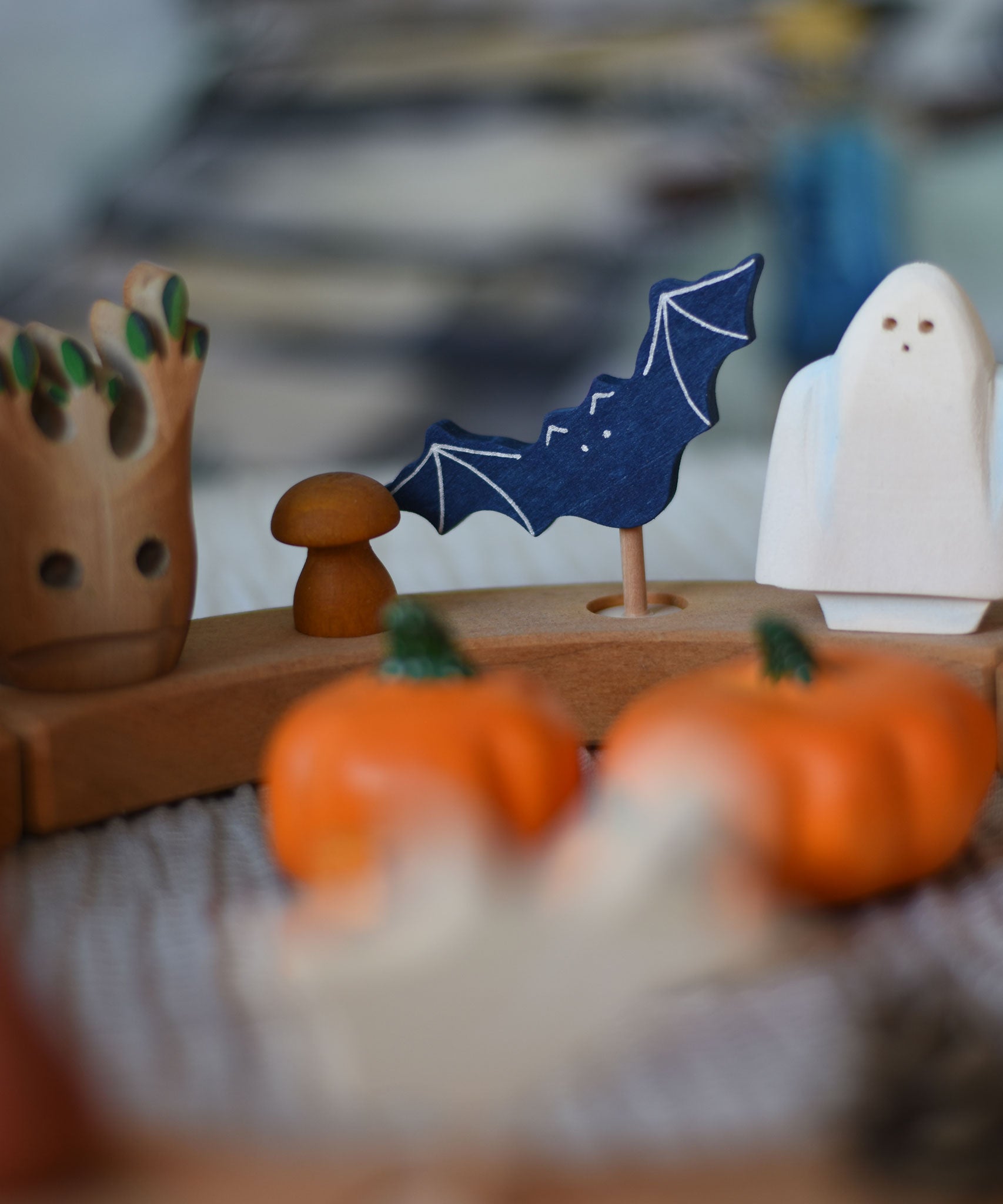 A Grimm's wooden bat decorative figure placed on a natural Grimm's celebration ring. The decorative figures are part of a wide range of figures and rings available here at Babipur.