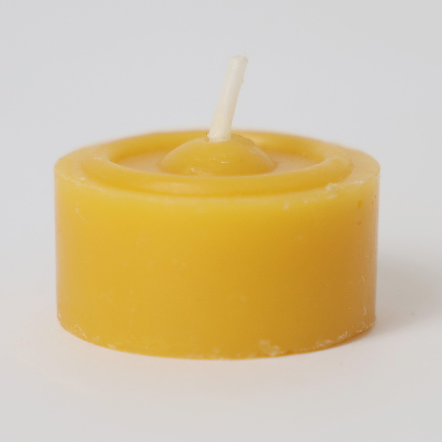 One 100% beeswax Grimm's tealight. It has a yellow colour and white wick
