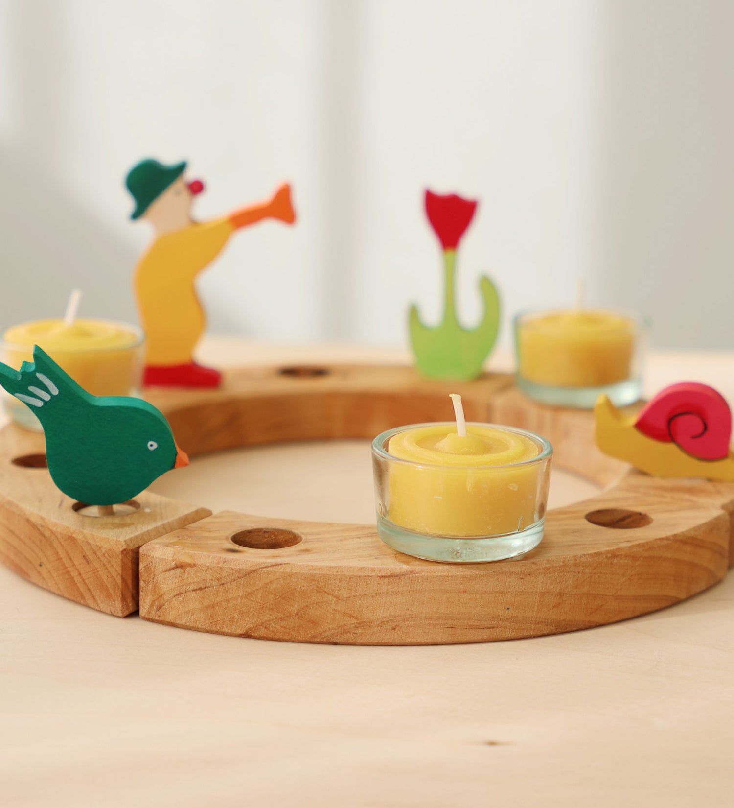 A celebration ring with Grimm's celebration figures and 100% beeswax tealights. 