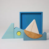 The blocks from the Grimm's blue building set taken out of the wooden storage tray. These Grimm's wooden block sets are part of a wide range of wooden toys available here at Babipur.