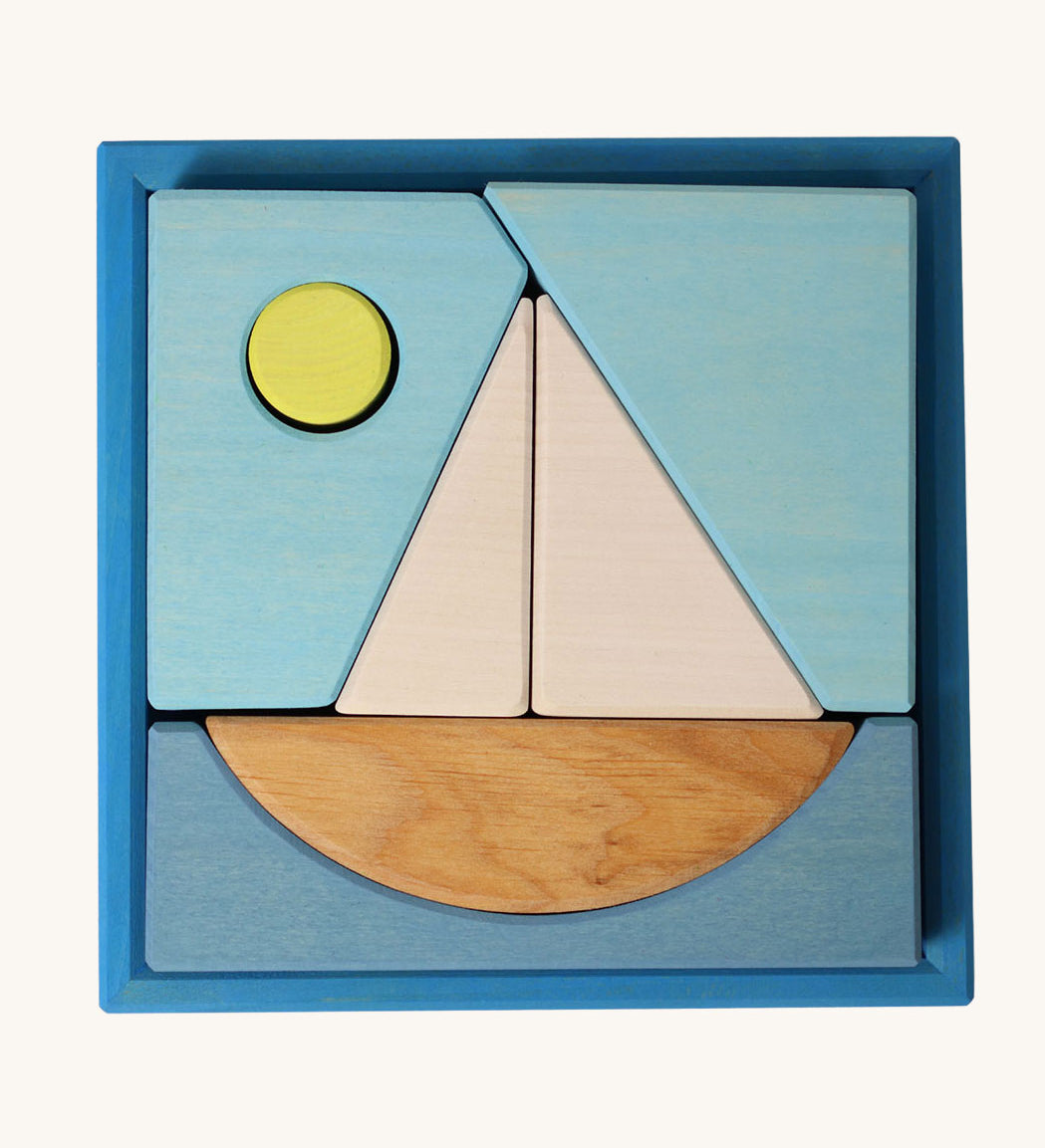 Grimm's Building Set Blue. A set of wooden blocks that form a sailing boat when placed in the blue coloured storage tray. These Grimm's toys are part of a wide range of wooden toys available here at Babipur. 