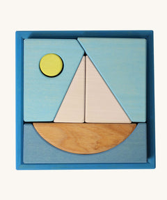 Grimm's Building Set Blue. A set of wooden blocks that form a sailing boat when placed in the blue coloured storage tray. These Grimm's toys are part of a wide range of wooden toys available here at Babipur. 
