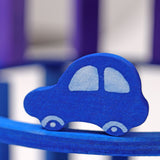 A close up of the Grimms wooden blue car figure from the counting and story telling set available at Babipur showing the hand painted detail