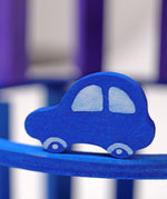 A close up of the Grimms wooden blue car figure from the counting and story telling set available at Babipur showing the hand painted detail