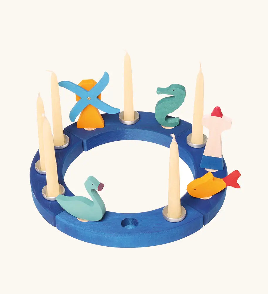 Grimm's blue celebration ring with a windmill, seahorse, lighthouse, fish and blue swan decorative figure