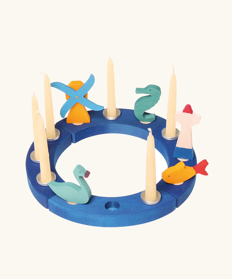Grimm's blue celebration ring with a windmill, seahorse, lighthouse, fish and blue swan decorative figure