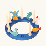 Grimm's blue celebration ring with a windmill, seahorse, lighthouse, fish and blue swan decorative figure