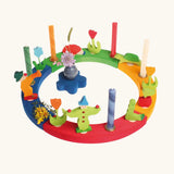 Grimm's wooden celebration ring displaying various decorative figures including clowns worm, hedgehog and tulips