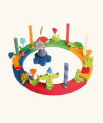 Grimm's wooden celebration ring displaying various decorative figures including clowns worm, hedgehog and tulips