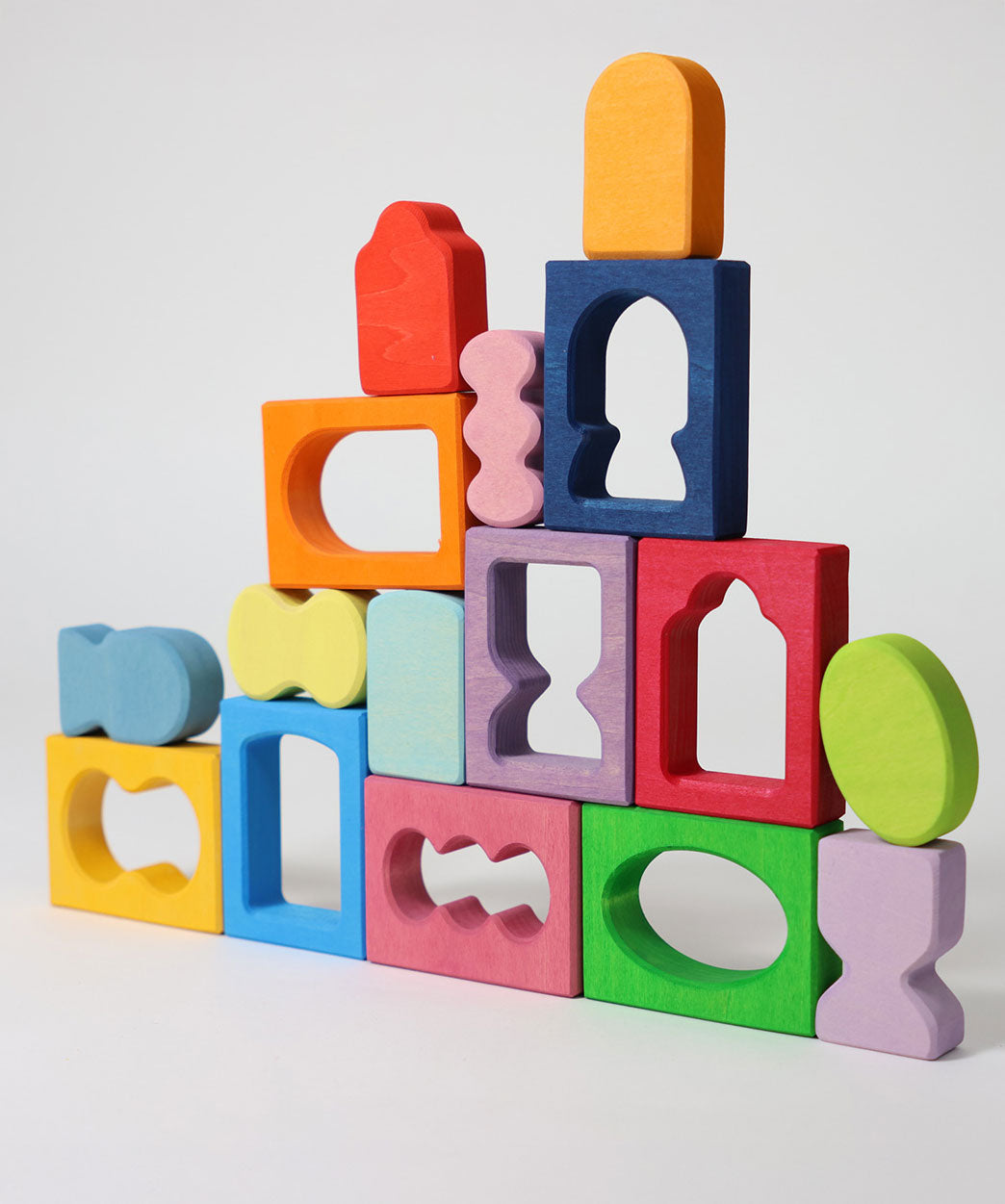 The blocks from the Grimm's Windows Building Set wooden blocks placed in a stack on top of each other. These Grimm's wooden blocks are part of a wide range of wooden toys available here at Babipur. 