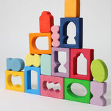 The blocks from the Grimm's Windows Building Set wooden blocks placed in a stack on top of each other. These Grimm's wooden blocks are part of a wide range of wooden toys available here at Babipur. 