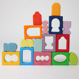 The blocks from the Grimm's Windows Building Set wooden blocks placed in a stack on top of each other. These Grimm's wooden blocks are part of a wide range of wooden toys available here at Babipur. 