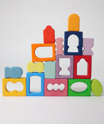 The blocks from the Grimm's Windows Building Set wooden blocks placed in a stack on top of each other. These Grimm's wooden blocks are part of a wide range of wooden toys available here at Babipur. 