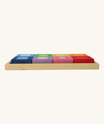 A side view of the Grimm's Windows Building Set wooden blocksin their tray. These Grimm's wooden blocks are part of a wide range of wooden toys available here at Babipur. 