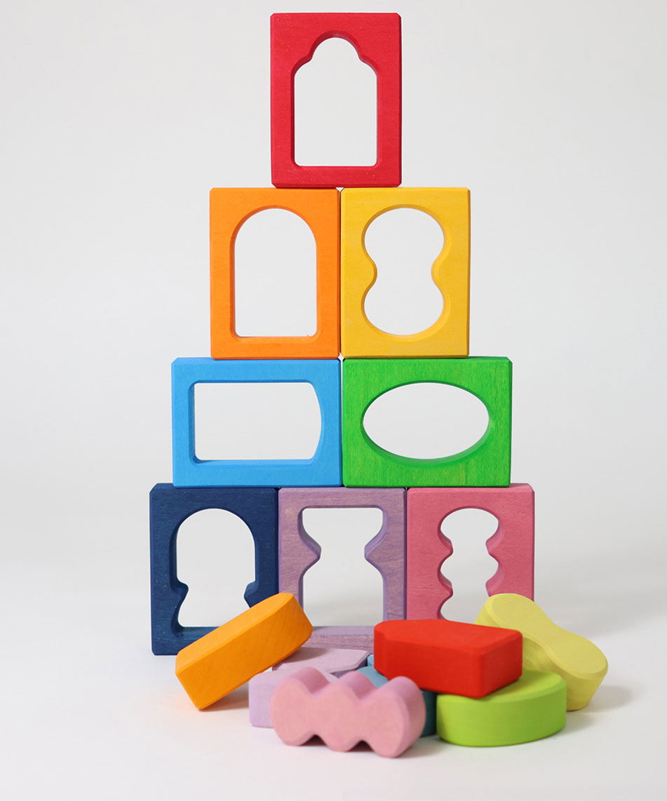 The blocks from the Grimm's Windows Building Set wooden blocks placed in a stack on top of each other. These Grimm's wooden blocks are part of a wide range of wooden toys available here at Babipur. 