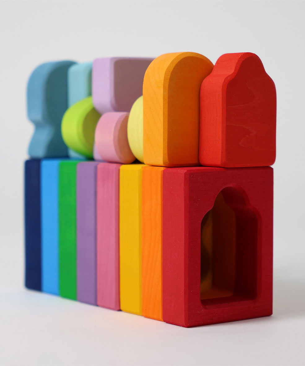 The windows and shaped from the Grimm's Windows Building Set wooden blocks all lined up. These Grimm's wooden blocks are part of a wide range of wooden toys available here at Babipur. 