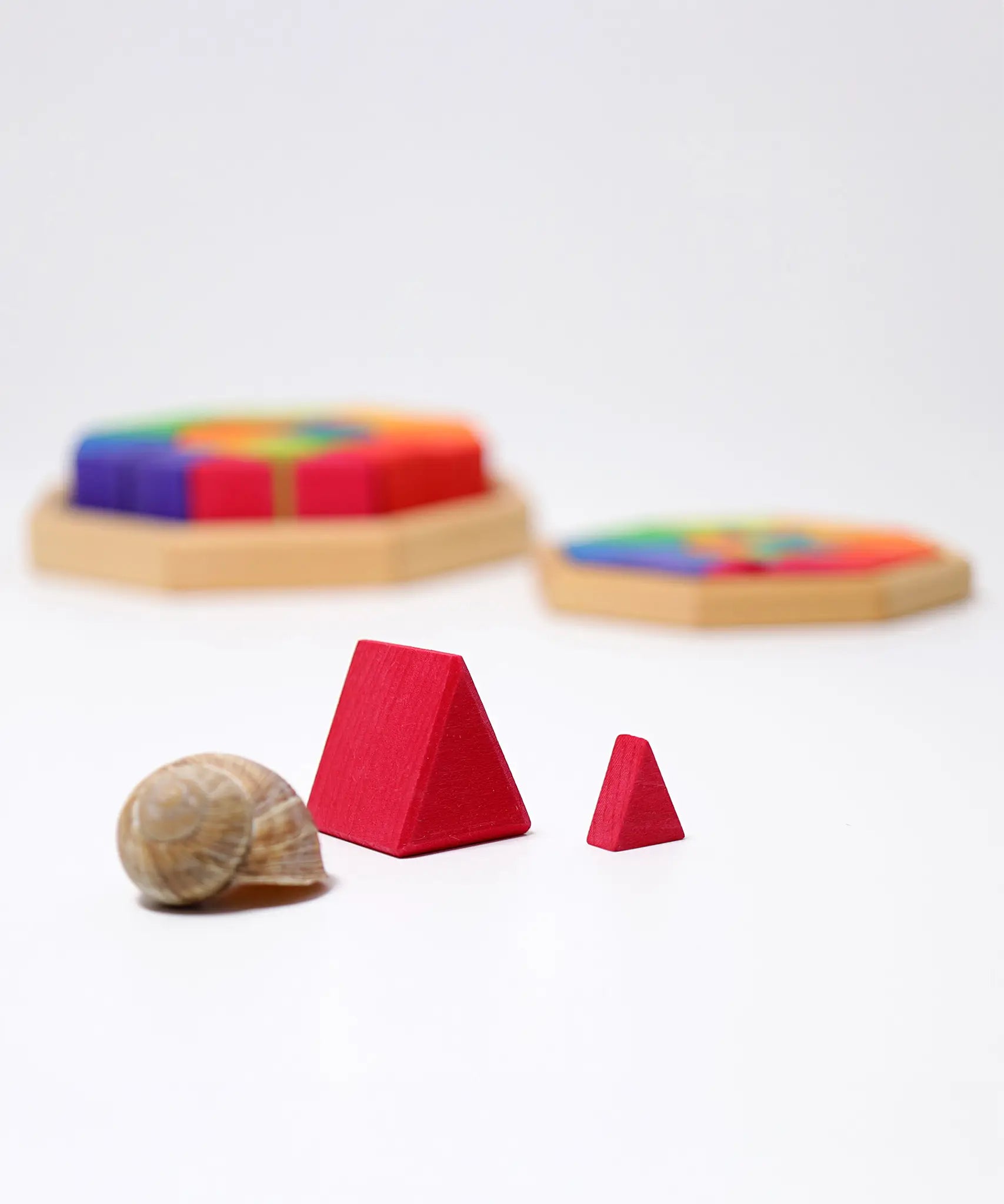 Close up of the large and small Grimm's Building Octagon Puzzle pieces next to each other.