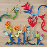 Grimm's Arcs in Squares Wooden Building Set blocks used to create a floral flatlay.