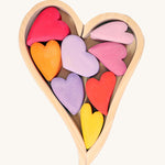 Grimm's Building Set Red Hearts. A wooden heart shaped frame with wooden hearts inside.