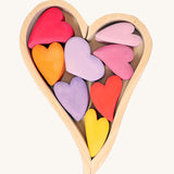 Grimm's Building Set Red Hearts. A wooden heart shaped frame with wooden hearts inside.