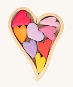 Grimm's Building Set Red Hearts. A wooden heart shaped frame with wooden hearts inside.