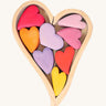 Grimm's Building Set Red Hearts. A wooden heart shaped frame with wooden hearts inside.