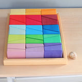 Grimm's sloping blocks building set in a wooden storage display tray placed on a wooden surface.