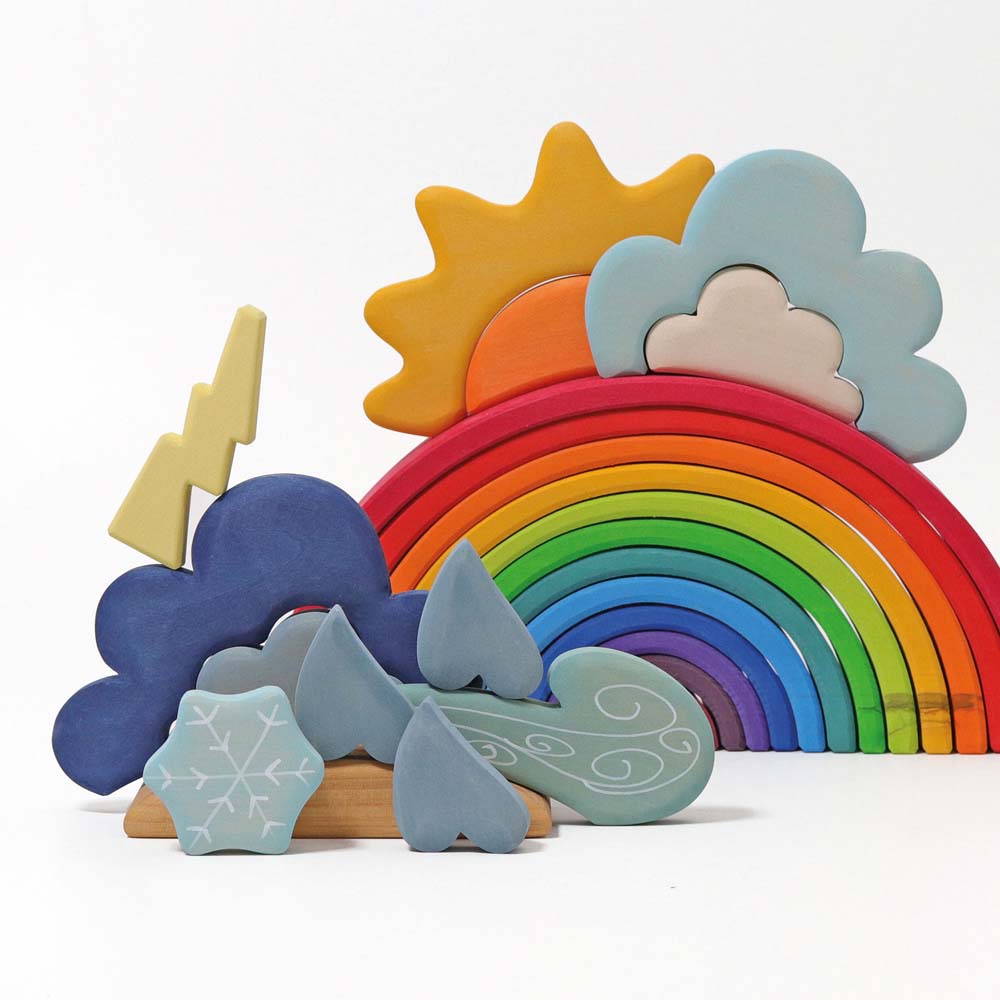 The Grimm's Wooden Weather Building Set set up alongside a 12 piece rainbow. 
