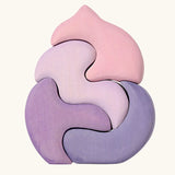 Back of the Grimm's casa coral wooden toy stacking puzzle. Four piece pink and lilac block puzzle.
