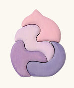 Back of the Grimm's casa coral wooden toy stacking puzzle. Four piece pink and lilac block puzzle.