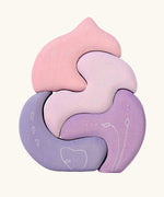 Grimm's casa coral wooden toy stacking puzzle. Four piece pink and lilac block puzzle.