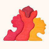 Back of the Grimm's casa glora wooden toy stacking puzzle. 4 piece puzzle in a mix of red and yellow colours.