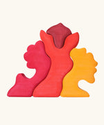 Back of the Grimm's casa glora wooden toy stacking puzzle. 4 piece puzzle in a mix of red and yellow colours.