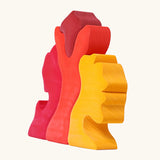 Back of the Grimm's casa glora wooden toy stacking puzzle. 4 piece puzzle in a mix of red and yellow colours.