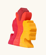 Back of the Grimm's casa glora wooden toy stacking puzzle. 4 piece puzzle in a mix of red and yellow colours.