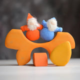 Grimm's handcrafted wooden casa sole blocks stacked with small dwarf dolls standing on top