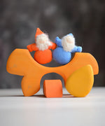 Grimm's handcrafted wooden casa sole blocks stacked with small dwarf dolls standing on top