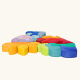 Collection of Grimm's casa wooden stacking puzzle toys laid flat. 