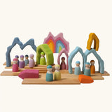 Grimm's cave arch stacker pastel wooden toy used in a small world play scene.