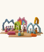 Grimm's cave arch stacker pastel wooden toy used in a small world play scene.