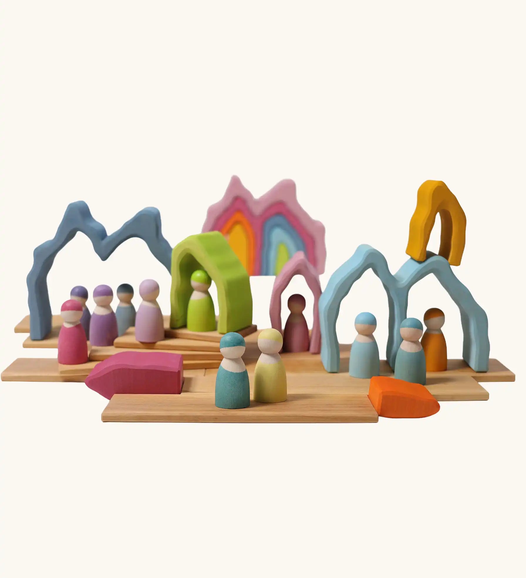 Grimm's cave arch stacker pastel wooden toy used in a small world play scene.