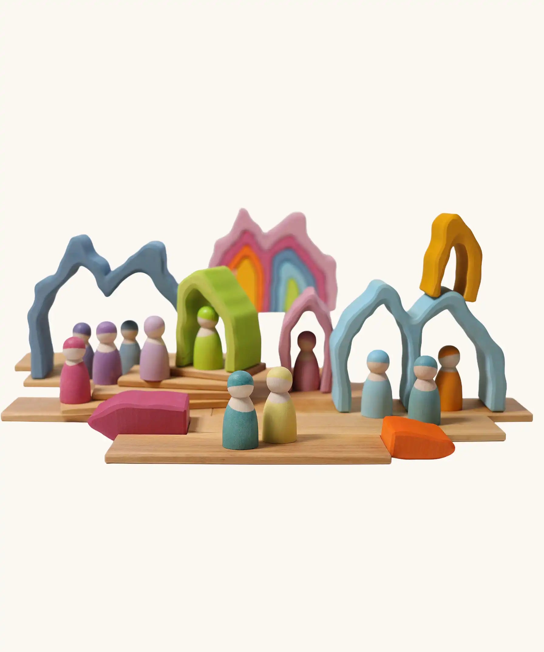 Grimm's cave arch stacker pastel wooden toy used in a small world play scene.
